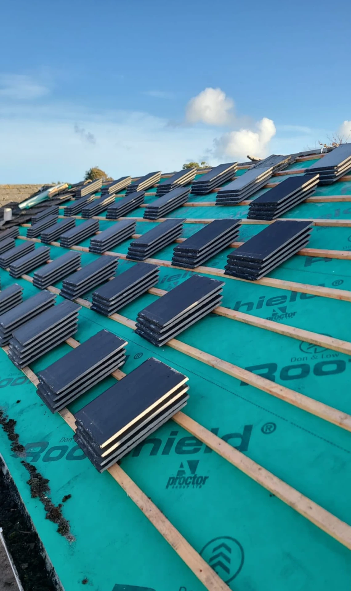 Slates loaded out on new battens and membrane